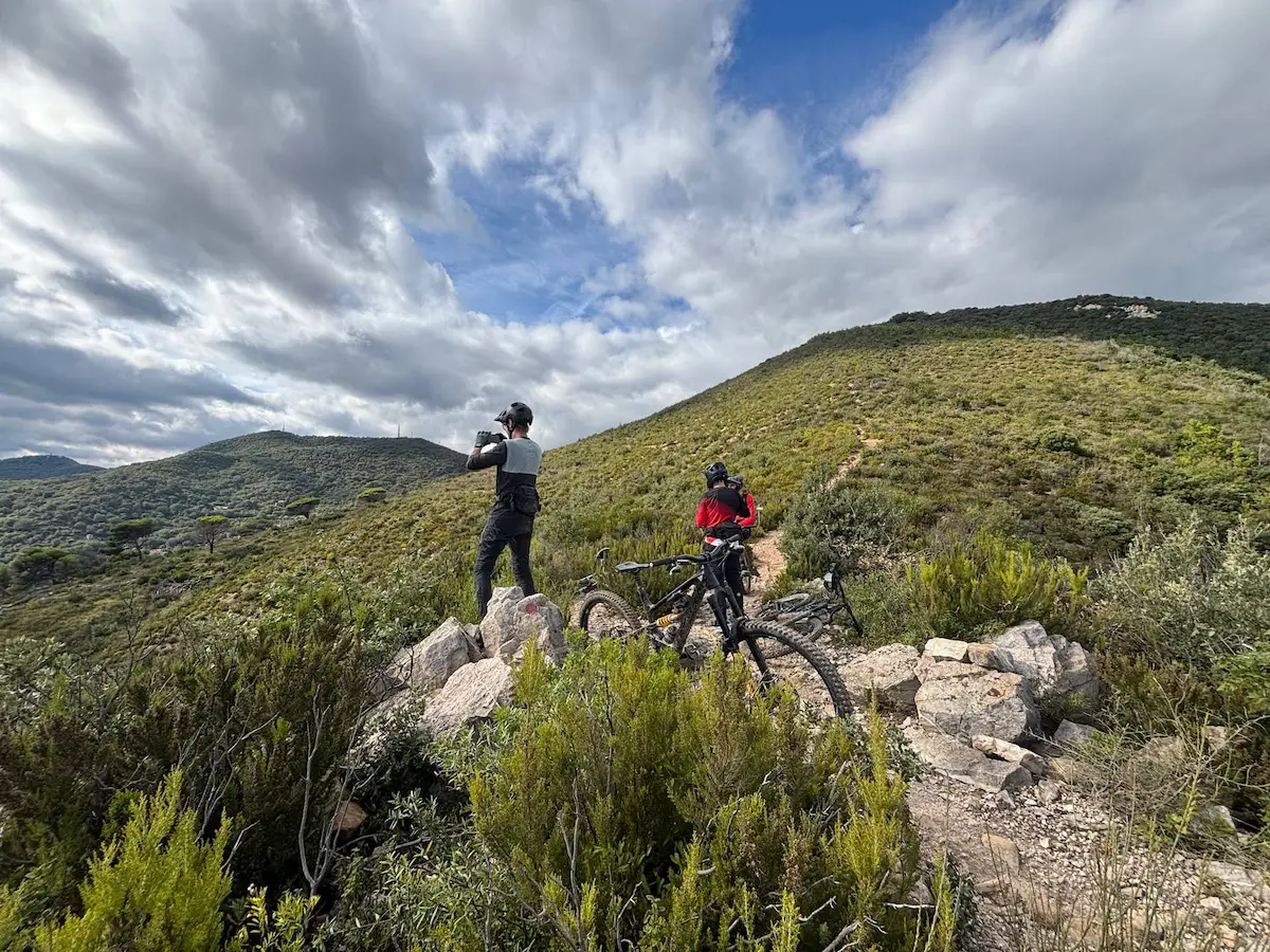 MTB tours Italy: two riders with mountain bikes enjoying the scenic mountain views in Liguria during the Azur Tour by Trails Unlimited.