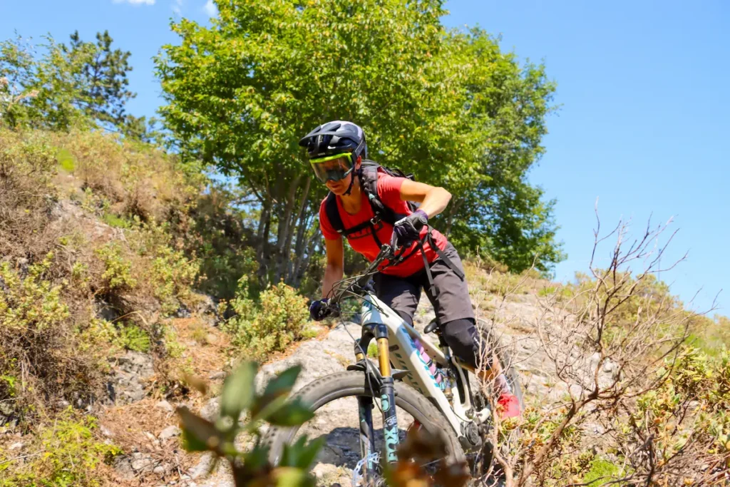 Rider enjoying a technical eMTB tour experience on the rocky trails of Finale Ligure with Trails Unlimited.