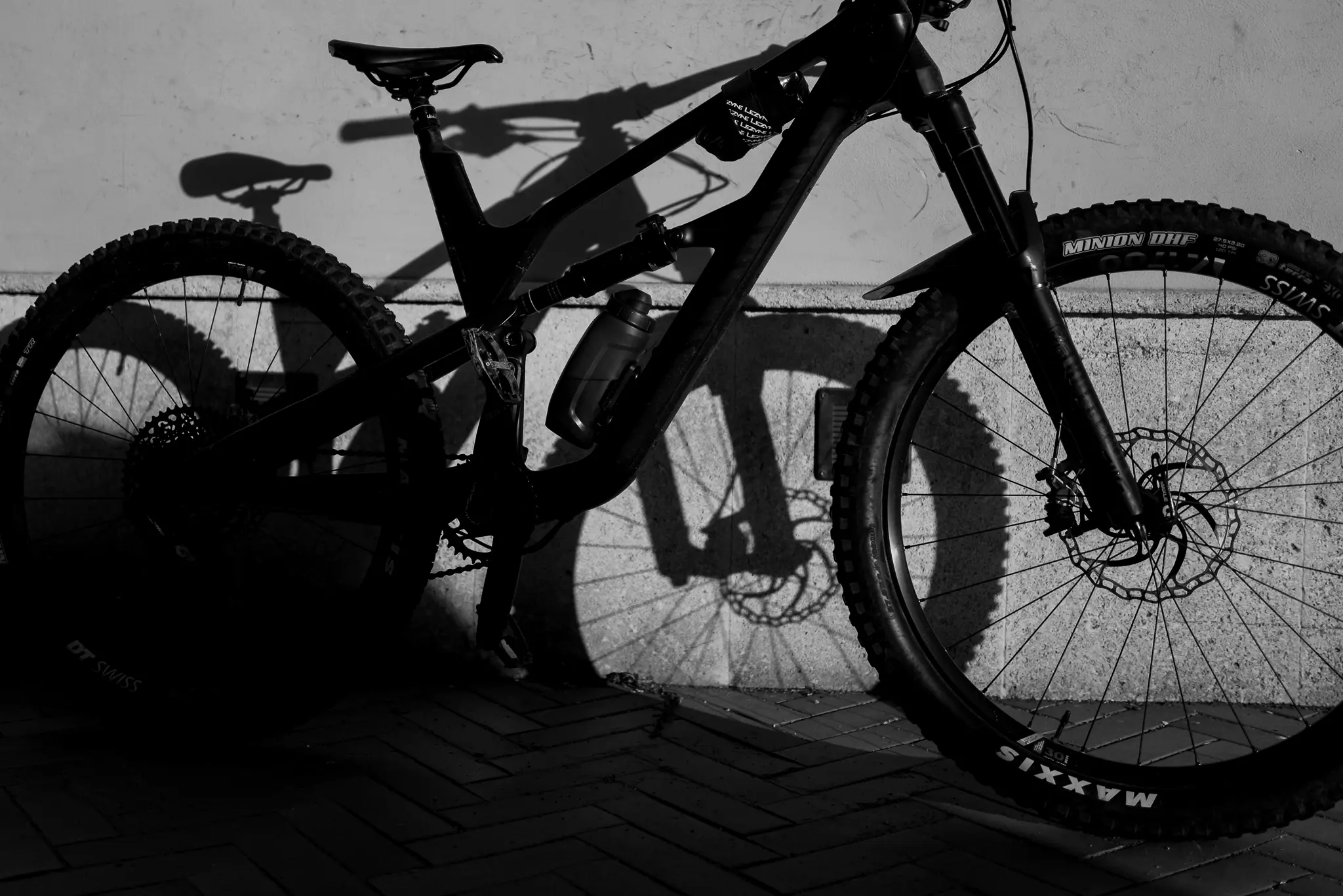 Close-up of a professional Enduro mountain bike with a focus on the front wheel and suspension, representing the high-quality technical gear recommended by Trails Unlimited.