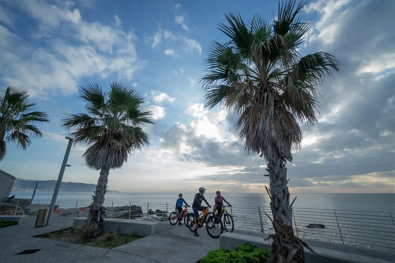 MTB riders arriving at the seaside in Bordighera, Italy, after completing the Bicknell Ciclovia mountain bike tour with Trails Unlimited.