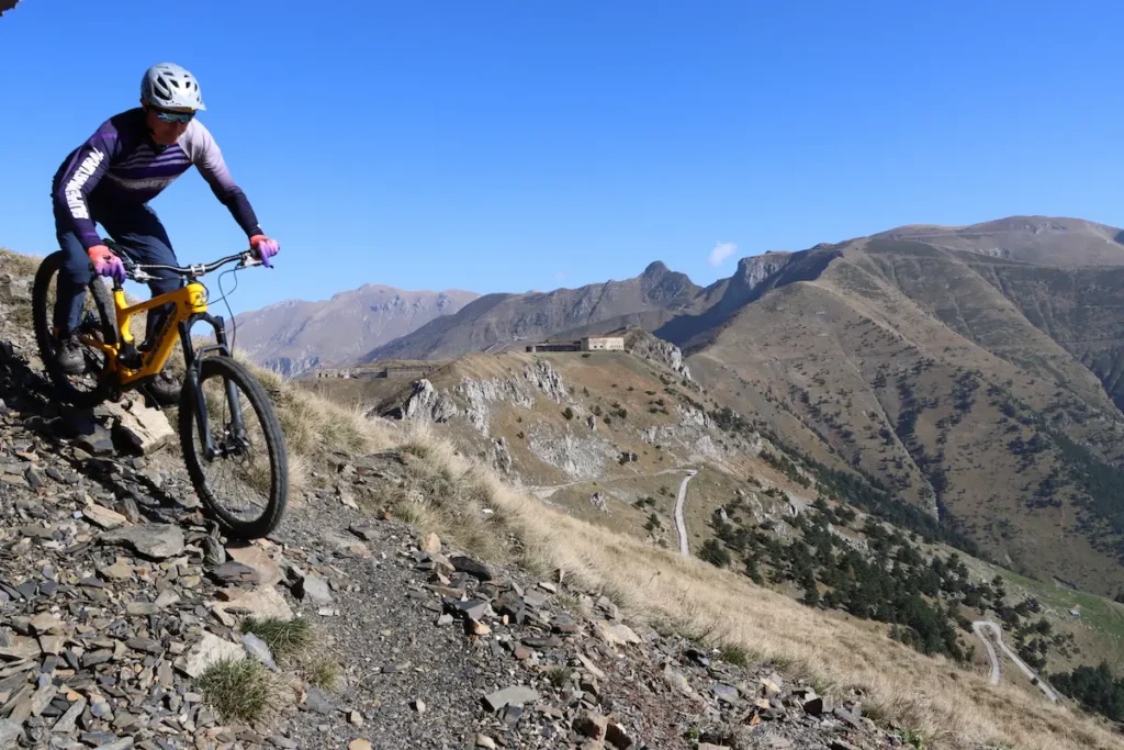 Trails Unlimited guide Stefano descending a rocky singletrack in the Roya Valley on an e-MTB tour.