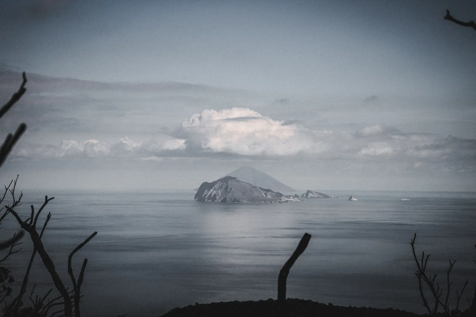 The volcanic profile of Stromboli island rising from the sea, captured during the Riding into the Lava MTB tour in the Aeolian Islands.