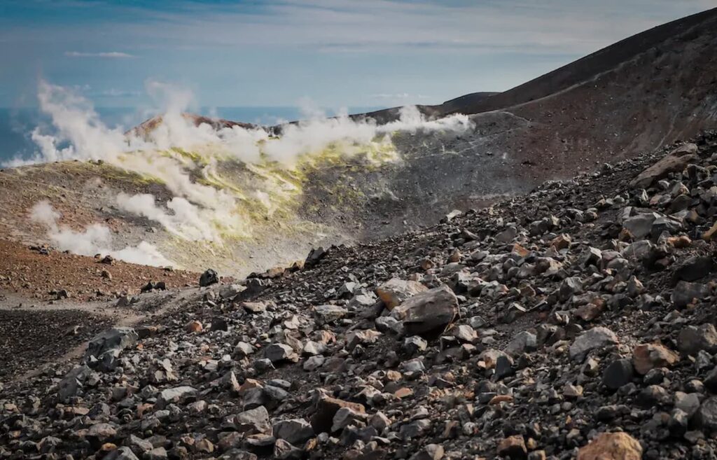 Panoramic view of active sulfur fumaroles on Vulcano island during a volcanic MTB tour in Sicily.