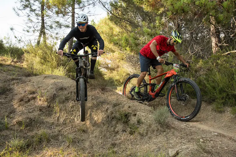 MTB guide Stefano from Trails Unlimited guiding an e-bike tour on the dusty singletracks of the Roya Valley towards Nice.