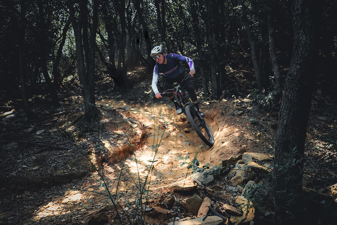 Electric mountain biking on a forested singletrack trail during the Bordighera E-MTB Tour.